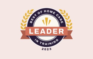 A circular badge with a banner across it reading "LEADER." Surrounding the central text, it says "BEST OF HOME CARE" and "IN TRAINING." The year "2023" is at the bottom, and the badge is decorated with laurel leaves on either side.