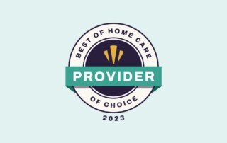 A circular badge with the text "Best of Home Care" at the top, "Provider of Choice" at the bottom, and "2023" underneath. The center features a dark circle with a green banner reading "Provider" across it and three yellow arcs above the banner.